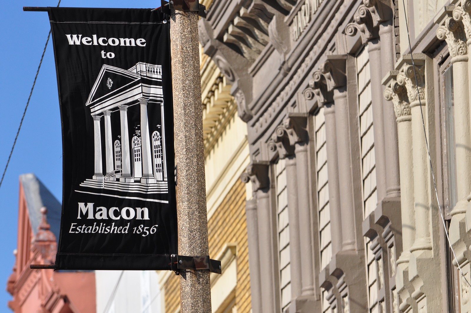 Welcome to Macon flag on a historical bank building.